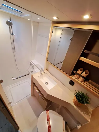  Yacht Photos Pics Modern bathroom in 2023 Lagoon 46 yacht with shower, sink, and storage.