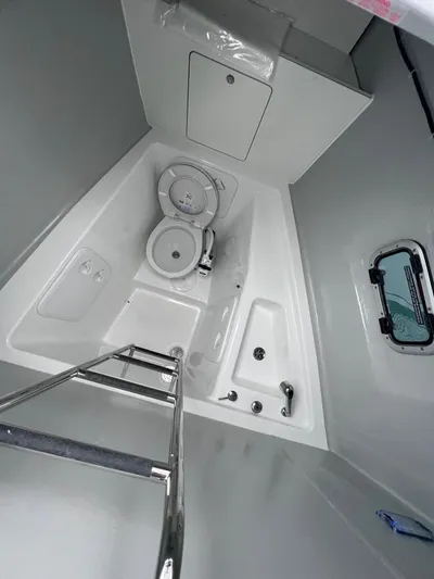  Yacht Photos Pics 2023 Lagoon 46 yacht bathroom with modern fixtures and compact design.