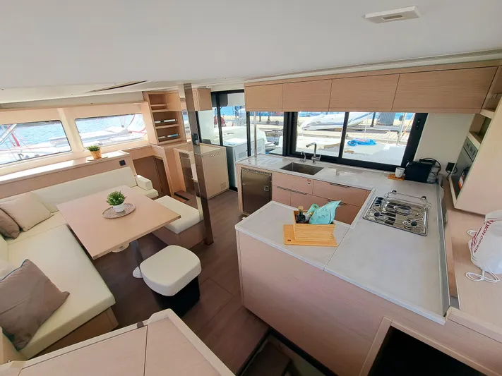  Yacht Photos Pics Luxurious interior of 2023 Lagoon 46 catamaran with modern kitchen and seating area.