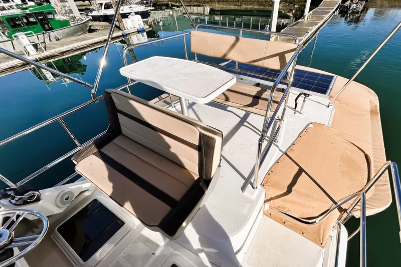 Serafina Yacht Photos Pics 2019 Ranger Tugs R-29 CB boat deck with seating and table at marina.