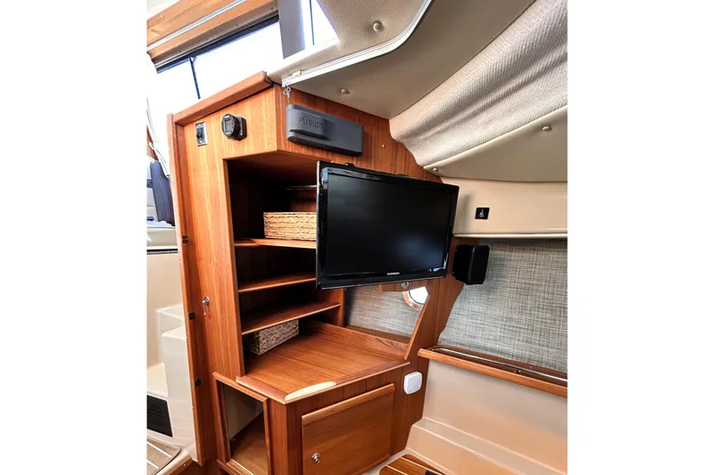 Serafina Yacht Photos Pics 2019 Ranger Tugs R-29 CB interior with wooden cabinetry and mounted TV.