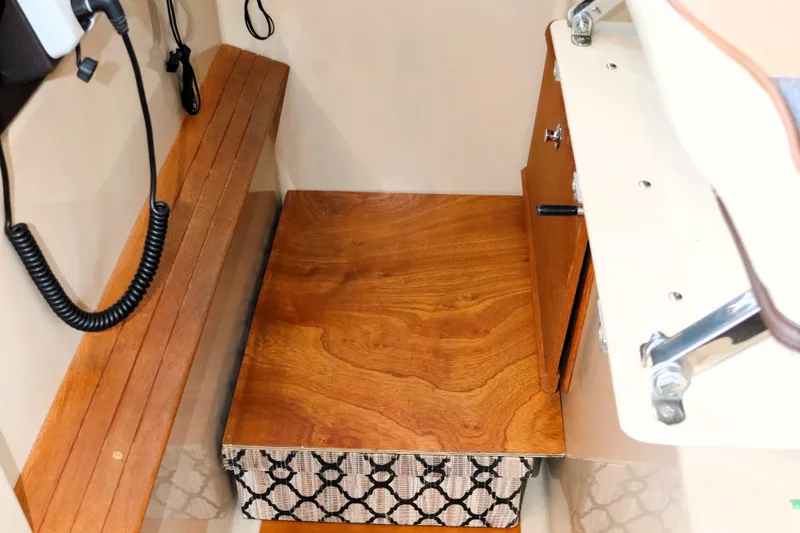 Serafina Yacht Photos Pics 2019 Ranger Tugs R-29 CB interior with wooden bench and storage compartment.