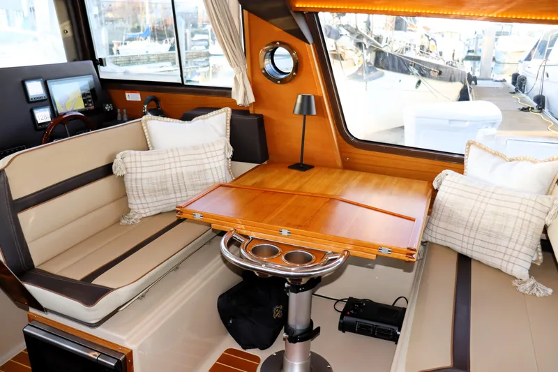 Serafina Yacht Photos Pics Interior of 2019 Ranger Tugs R-29 CB with cozy seating and wooden table.
