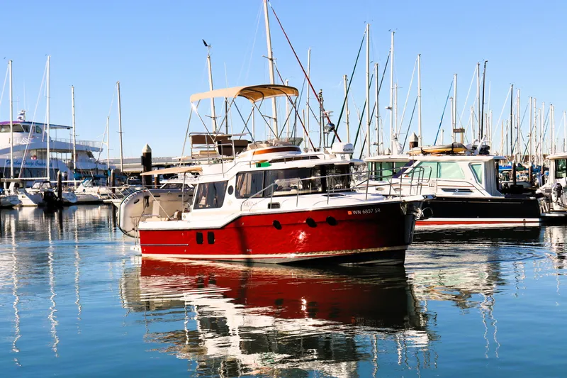 Serafina Yacht Photos Pics 2019 Ranger Tugs R-29 CB boat docked in a marina, surrounded by sailboats.
