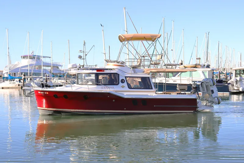 Serafina Yacht Photos Pics 2019 Ranger Tugs R-29 CB boat docked in marina, surrounded by sailboats.