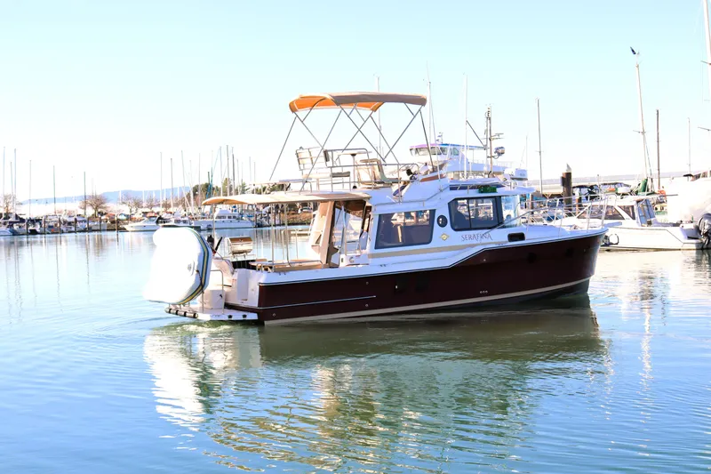 Serafina Yacht Photos Pics 2019 Ranger Tugs R-29 CB boat docked in a marina, reflecting on calm water.