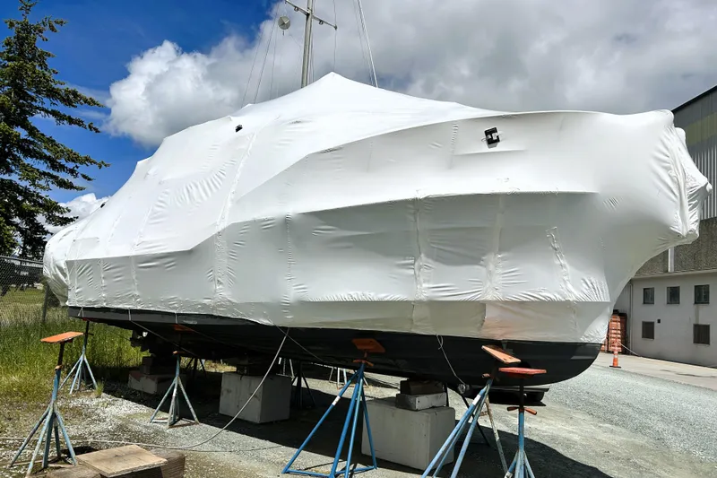 Serafina Yacht Photos Pics 2019 Ranger Tugs R-29 CB boat covered in white tarp, supported on stands outdoors.