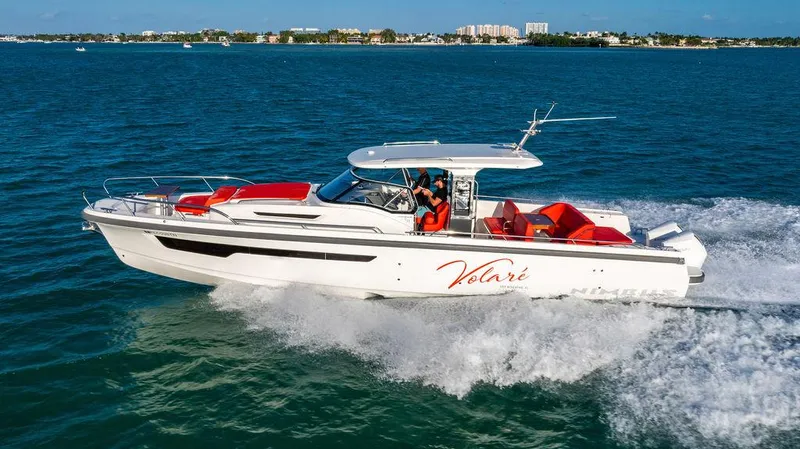 Volare Yacht Photos Pics 2023 Nimbus T11 boat cruising on blue ocean waters with red seating.
