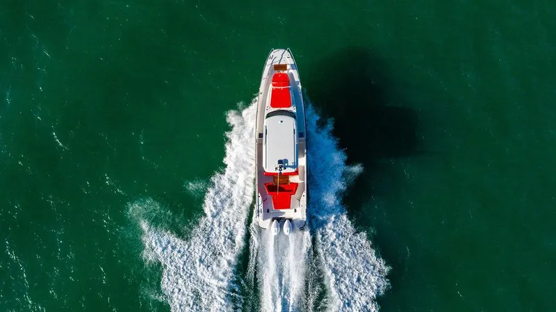 Volare Yacht Photos Pics Aerial view of 2023 Nimbus T11 boat cruising on green water.