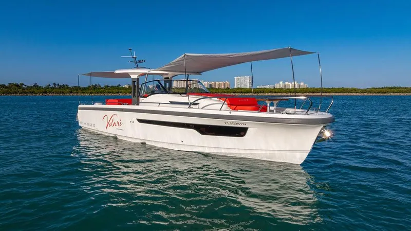 Volare Yacht Photos Pics 2023 Nimbus T11 boat on water with canopy and red seating.