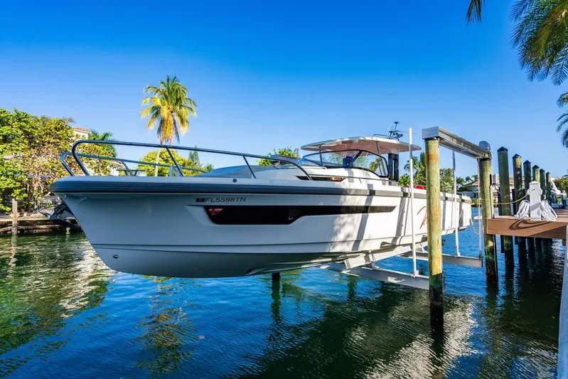 Volare Yacht Photos Pics 2023 Nimbus T11 boat docked on a lift in a tropical setting.