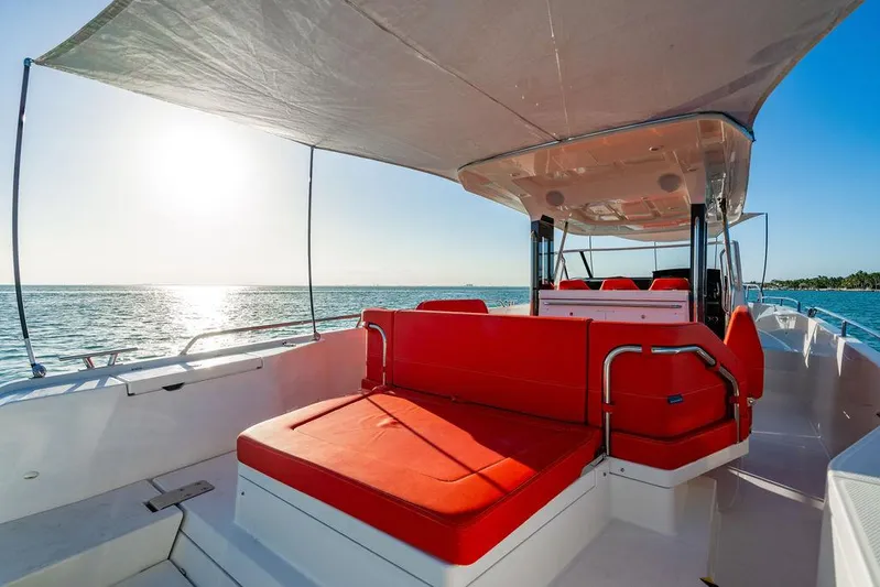 Volare Yacht Photos Pics 2023 Nimbus T11 boat with red seating, sunshade, and ocean view.