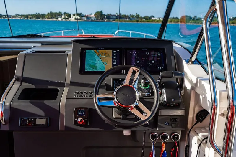 Volare Yacht Photos Pics 2023 Nimbus T11 boat dashboard with steering wheel and navigation display.