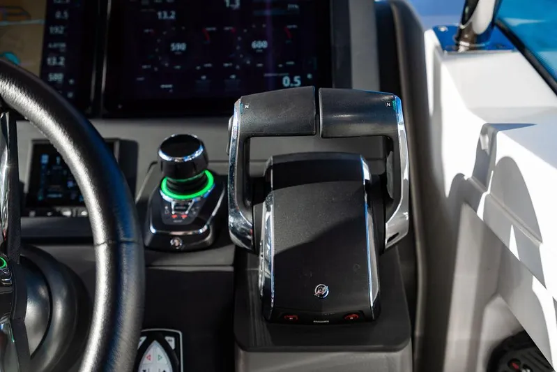 Volare Yacht Photos Pics Control panel of 2023 Nimbus T11 boat with steering wheel and throttle lever.