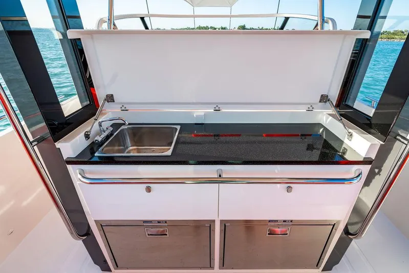 Volare Yacht Photos Pics Outdoor kitchen on 2023 Nimbus T11 boat with sink and storage drawers.