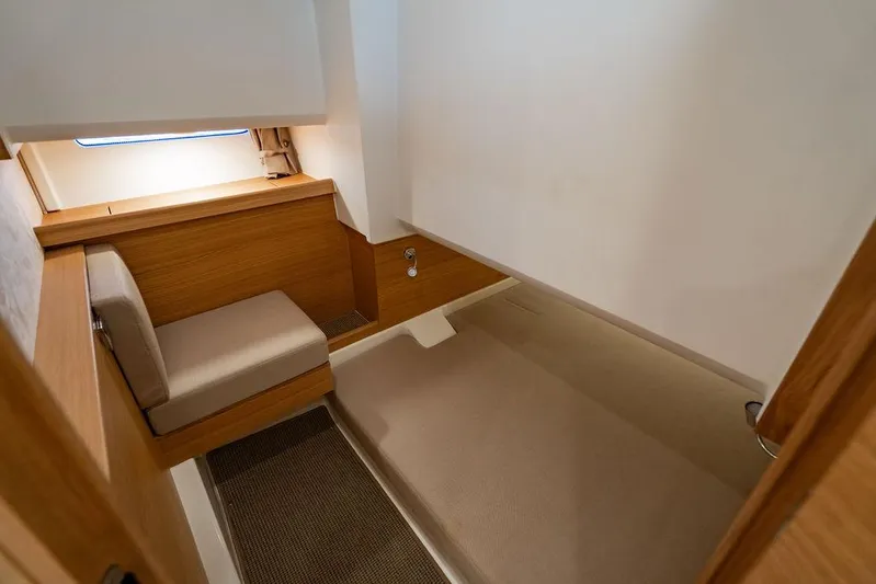 Volare Yacht Photos Pics 2023 Nimbus T11 interior cabin with wooden accents and seating area.