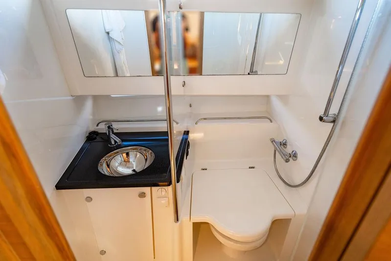 Volare Yacht Photos Pics Compact bathroom in 2023 Nimbus T11 boat with sink, toilet, and shower.