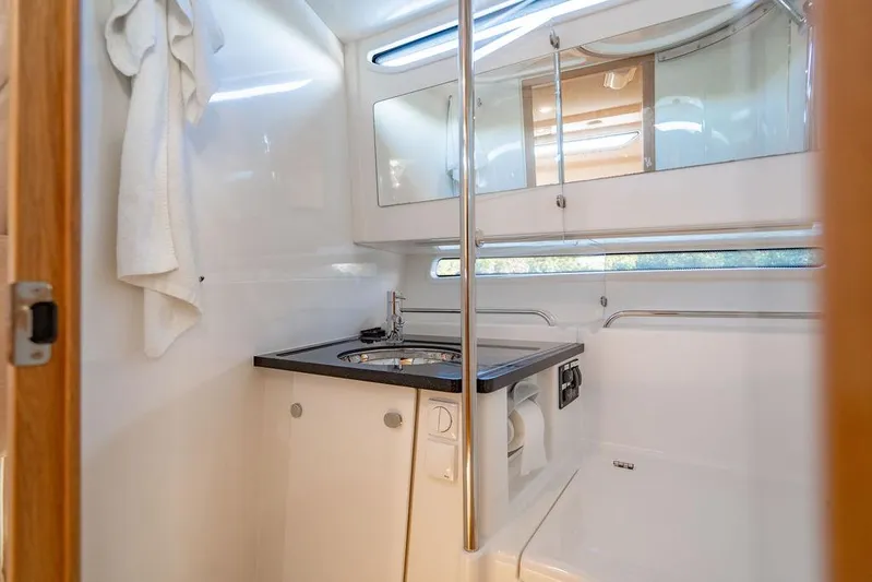 Volare Yacht Photos Pics Modern bathroom interior in 2023 Nimbus T11 boat, featuring sleek design and compact amenities.