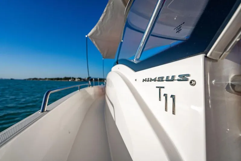 Volare Yacht Photos Pics 2023 Nimbus T11 boat on water, showcasing sleek design and branding.
