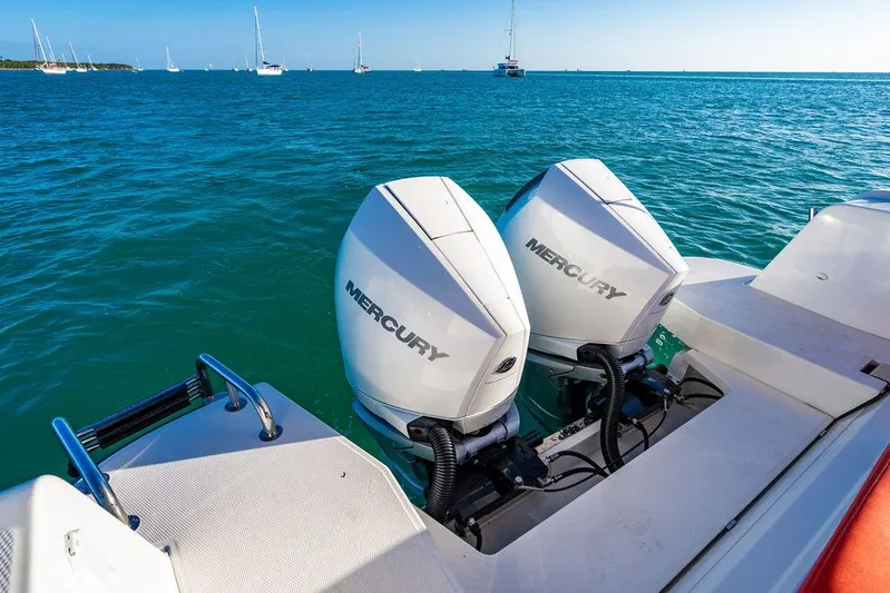 Volare Yacht Photos Pics Twin Mercury outboard engines on a 2023 Nimbus T11 boat, sailing in clear blue waters.