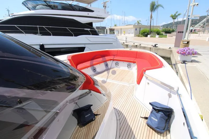 S Yacht Photos Pics 2024 Frauscher 1414 Demon Air yacht with red seating, docked at a marina.