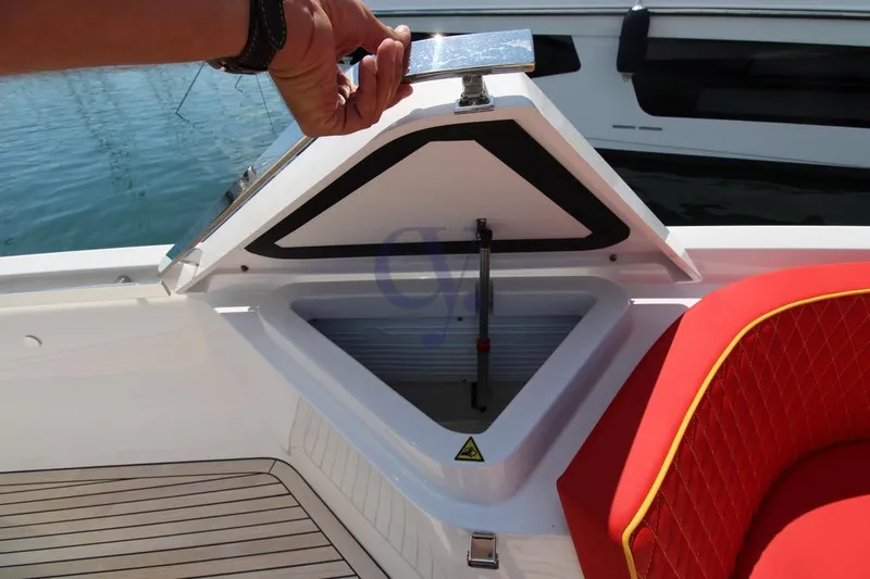 S Yacht Photos Pics 2024 Frauscher 1414 Demon Air boat with open storage compartment and red seating.