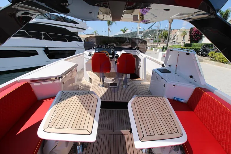 S Yacht Photos Pics 2024 Frauscher 1414 Demon Air luxury yacht interior with red seating and wooden deck.