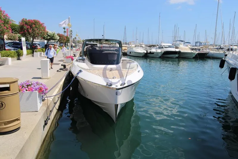 S Yacht Photos Pics 2024 Frauscher 1414 Demon Air yacht docked in a sunny marina.