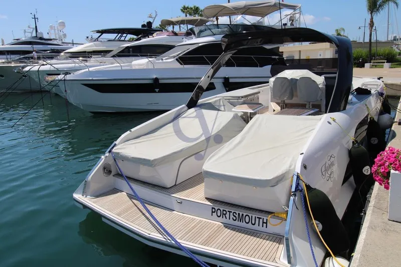 S Yacht Photos Pics 2024 Frauscher 1414 Demon Air yacht docked in a marina, covered and ready for sailing.