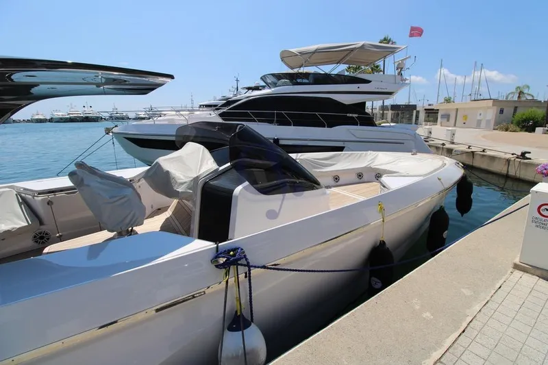 S Yacht Photos Pics 2024 Frauscher 1414 Demon Air yacht docked at a marina under clear blue skies.