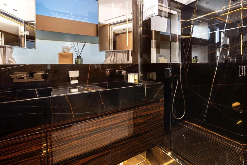 Nangara Yacht Photos Pics Luxurious bathroom in 2024 Sanlorenzo SL 106 Asymmetric yacht with sleek black marble design.