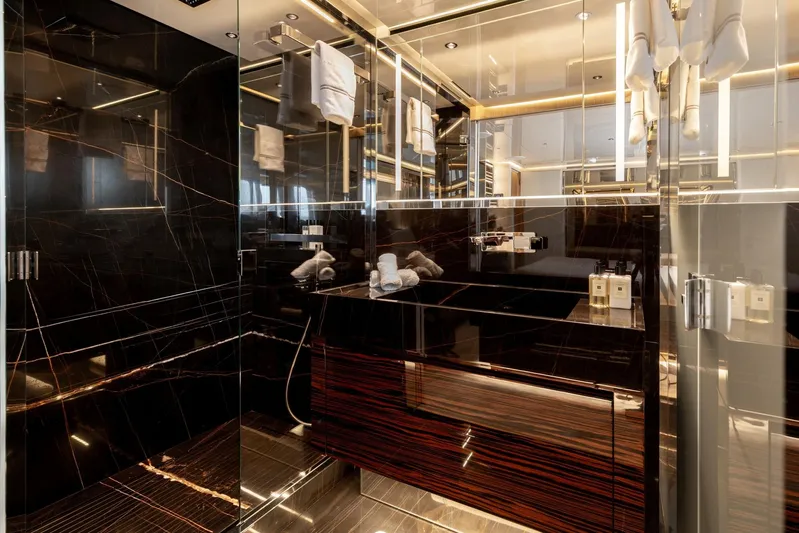 Nangara Yacht Photos Pics Luxurious bathroom interior of 2024 Sanlorenzo SL 106 Asymmetric yacht with elegant black marble design.