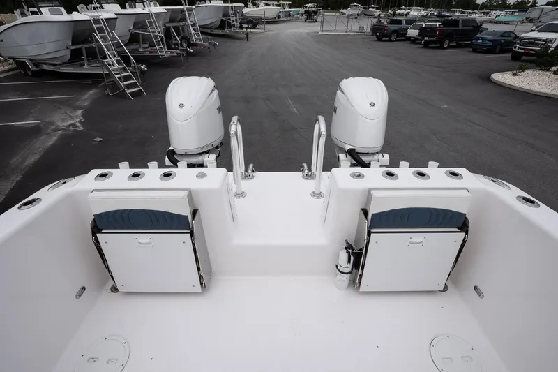  Yacht Photos Pics 2025 Twin Vee 260 GFX2 CC boat with dual engines, docked in a marina.