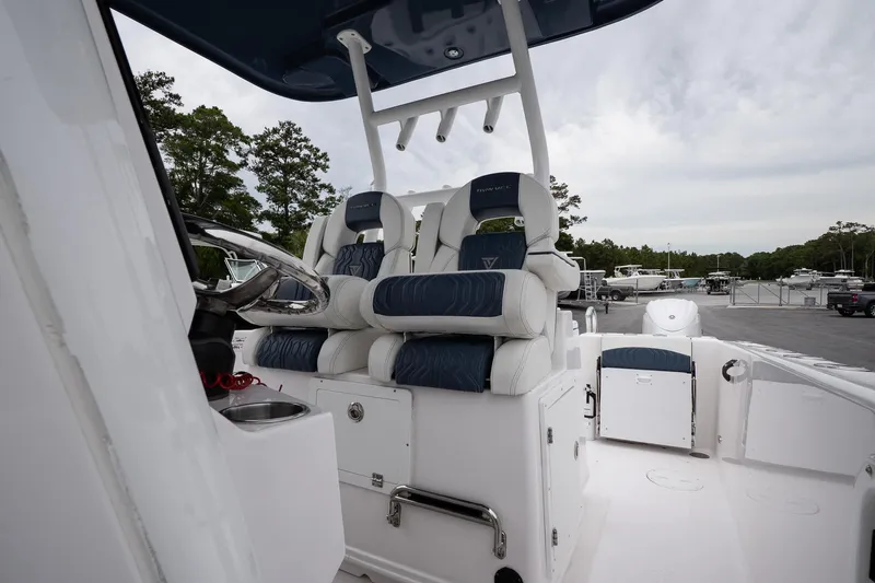  Yacht Photos Pics 2025 Twin Vee 260 GFX2 CC boat interior with dual cushioned seats and steering console.