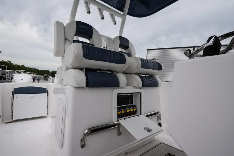  Yacht Photos Pics 2025 Twin Vee 260 GFX2 CC boat interior with cushioned seating and control panel.