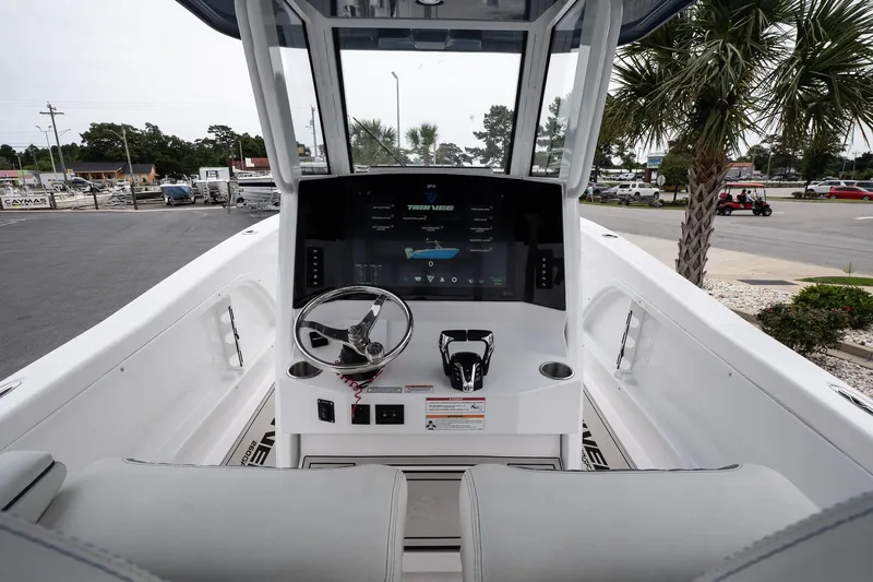  Yacht Photos Pics 2025 Twin Vee 260 GFX2 CC boat dashboard with steering wheel and digital display.
