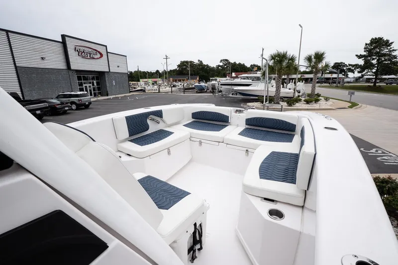  Yacht Photos Pics 2025 Twin Vee 260 GFX2 CC boat with spacious seating, displayed at a dealership.