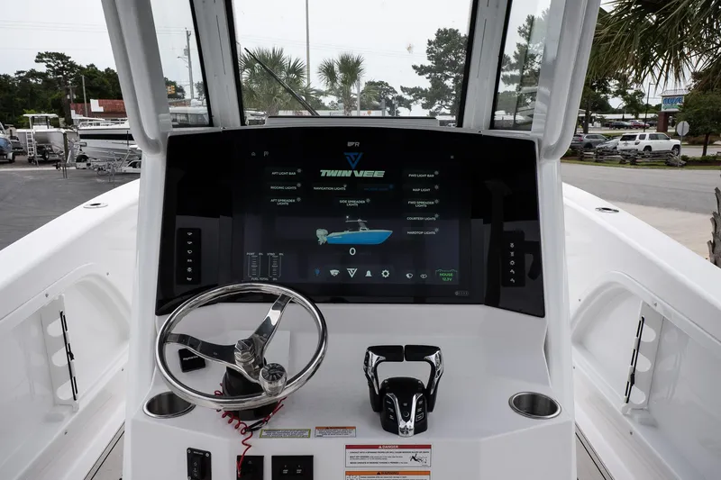  Yacht Photos Pics 2025 Twin Vee 260 GFX2 CC boat dashboard with steering wheel and digital display.