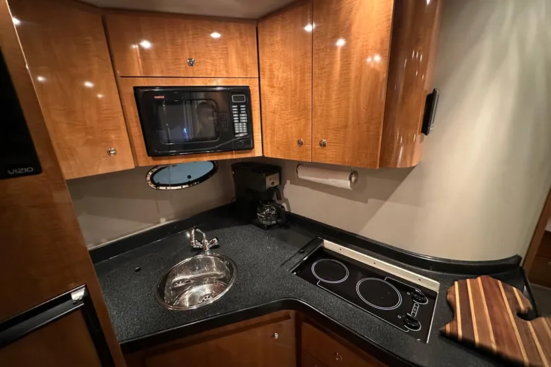 .38 Special Yacht Photos Pics 2004 Regal Commodore 3860 yacht kitchen with microwave, sink, and stovetop.
