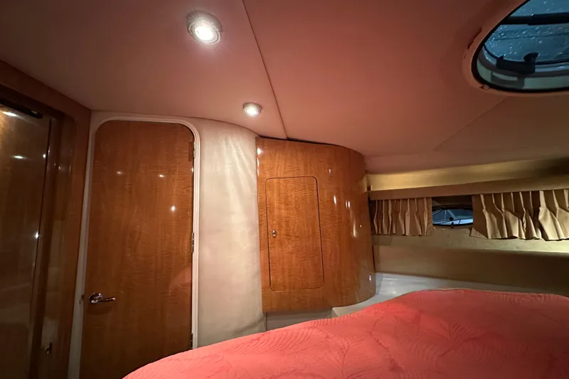 .38 Special Yacht Photos Pics Luxurious cabin interior of 2004 Regal Commodore 3860 yacht with wood paneling and cozy lighting.