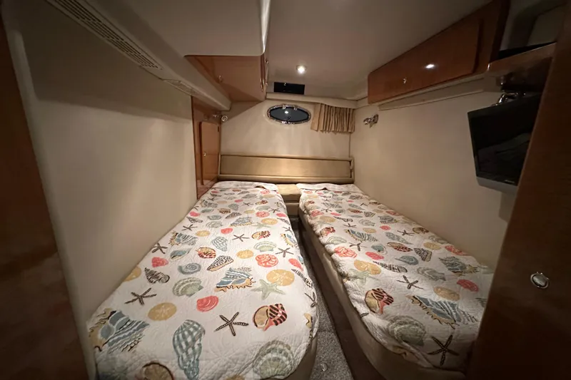 .38 Special Yacht Photos Pics 2004 Regal Commodore 3860 cabin with twin beds and nautical-themed bedding.