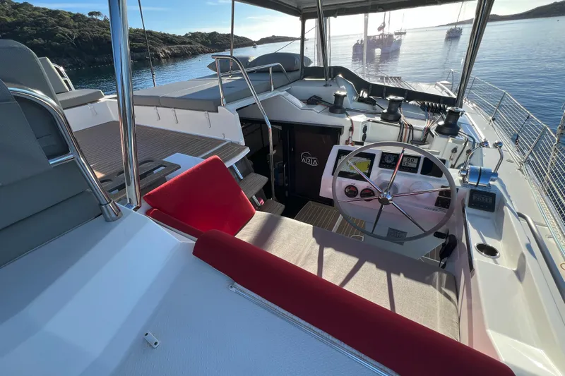 Aria Yacht Photos Pics 2023 Fountaine Pajot Elba 45 Catamaran helm with scenic ocean view.