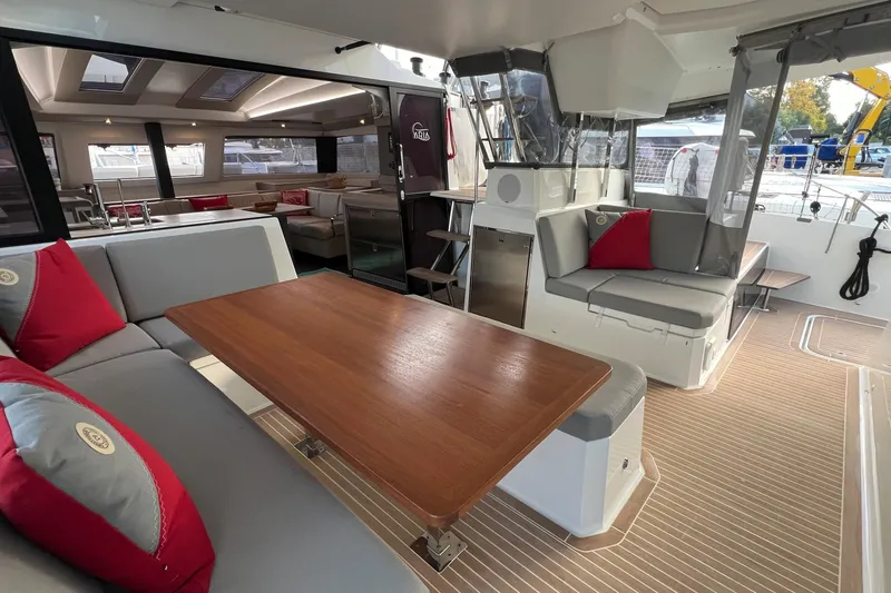 Aria Yacht Photos Pics Luxurious interior of 2023 Fountaine Pajot Elba 45 Catamaran with elegant seating and wooden table.