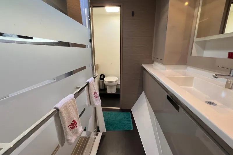 Aria Yacht Photos Pics Modern bathroom interior of 2023 Fountaine Pajot Elba 45 Catamaran, featuring sleek design and amenities.