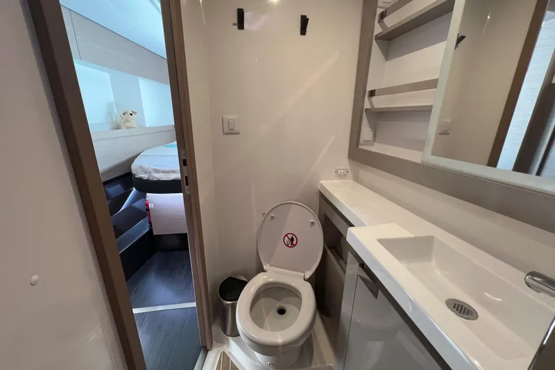Aria Yacht Photos Pics 2023 Fountaine Pajot Elba 45 Catamaran bathroom with modern fixtures and adjacent bedroom.