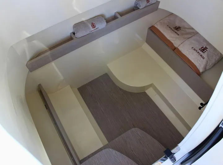  Yacht Photos Pics 2024 Capoforte FX270 cabin interior with cushions and bedding, showcasing modern design and comfort.