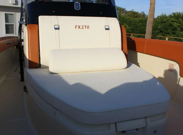  Yacht Photos Pics 2024 Capoforte FX270 boat seat with white upholstery and brown accents.