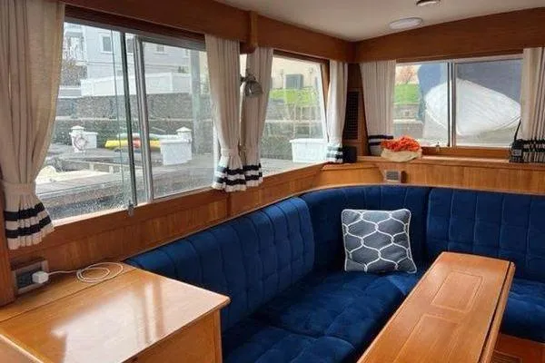 Shearwater Yacht Photos Pics Interior of 2000 Grand Banks 36 Classic yacht with blue seating and wooden accents.