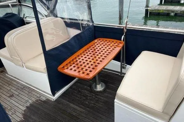 Shearwater Yacht Photos Pics Grand Banks 36 Classic 2000 boat interior with wooden table and cushioned seating.