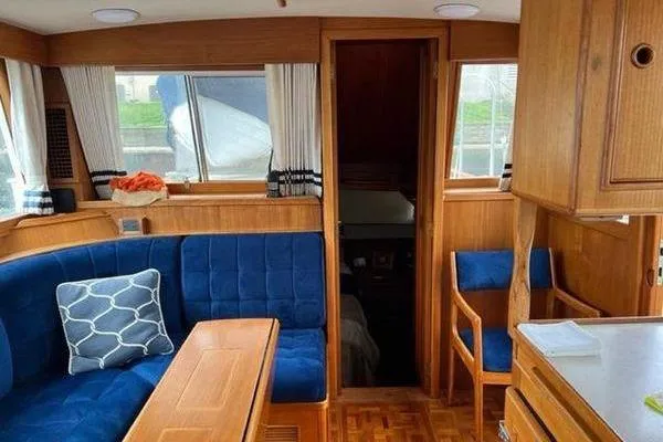 Shearwater Yacht Photos Pics Interior of 2000 Grand Banks 36 Classic yacht with blue seating and wooden finishes.